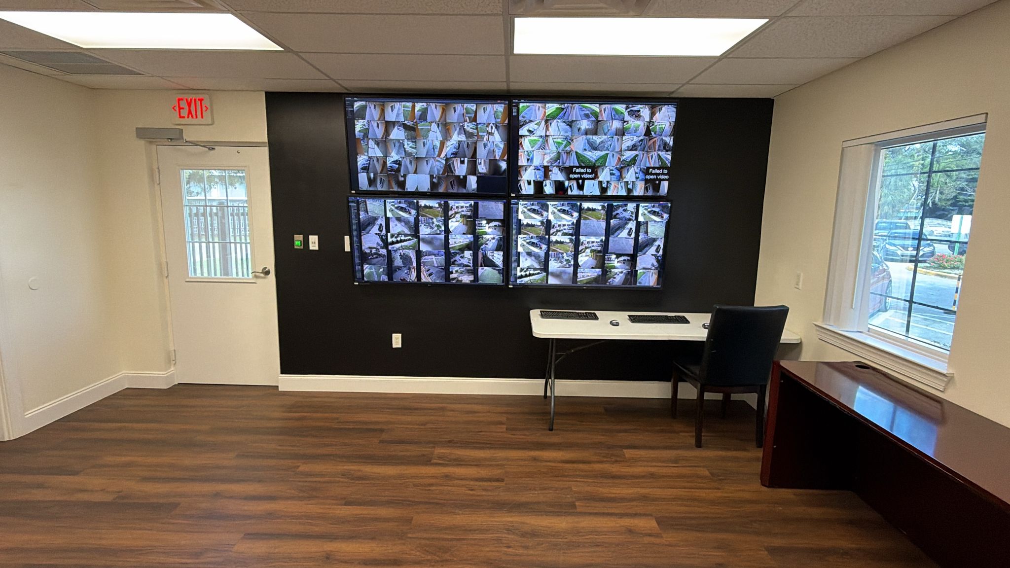 Glorieta Gardens police substation with four wall-mounted security monitoring displays