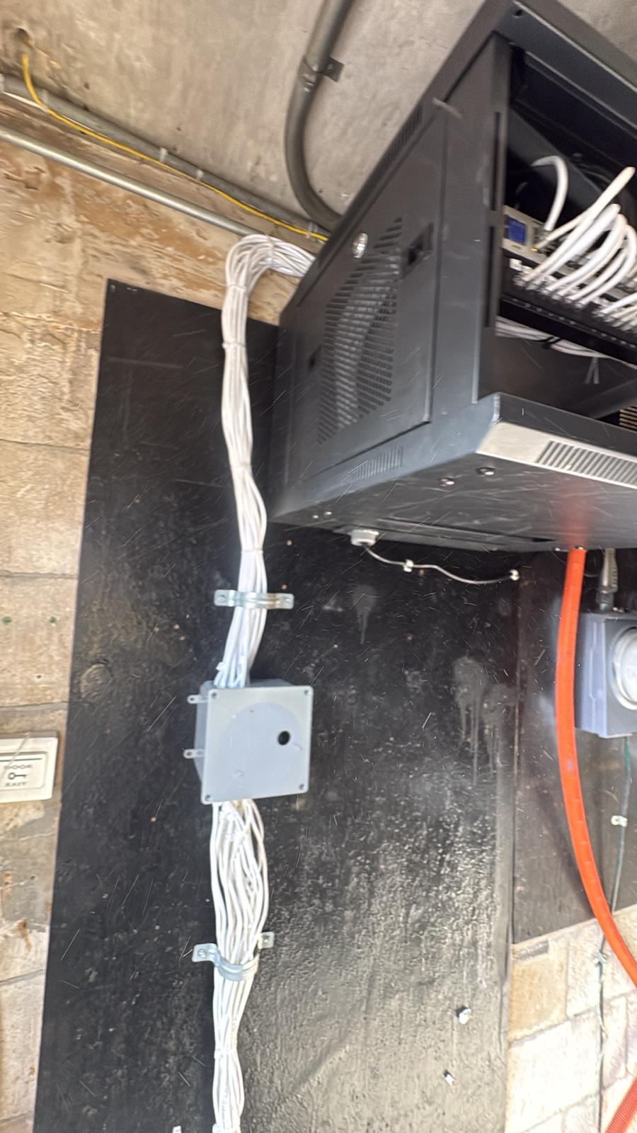 Organized low-voltage cable pathways feeding a network rack